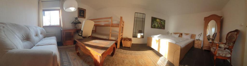 a living room with a couch and a bed at Sleep & Go - Sechsbettzimmer inkl 2 Luftbetten mit Gemeinschaftsbad in Sonthofen