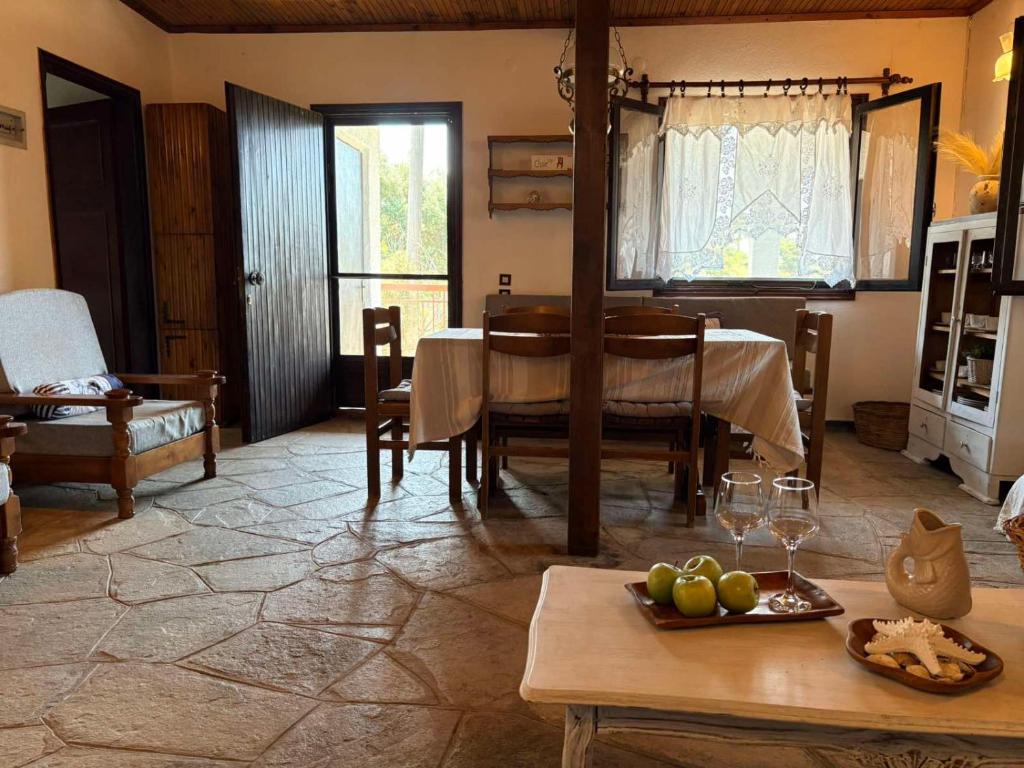 a living room with a table and a room with a dining room at Fisherman's Cove Epanomi in Epanomi