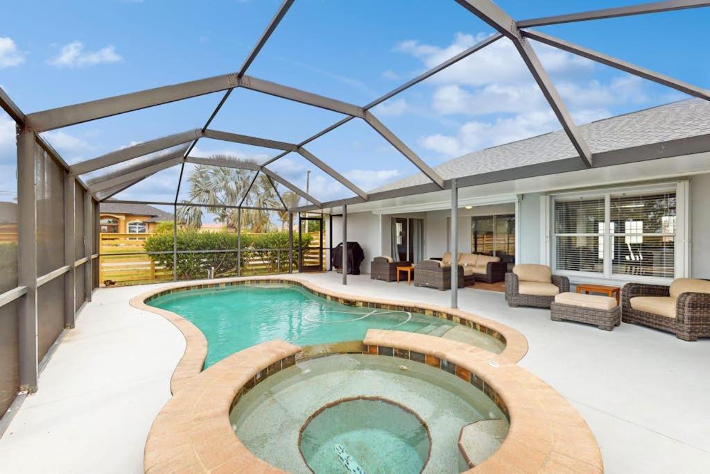 a swimming pool in a house with a glass roof at Little EsCape in Matlacha