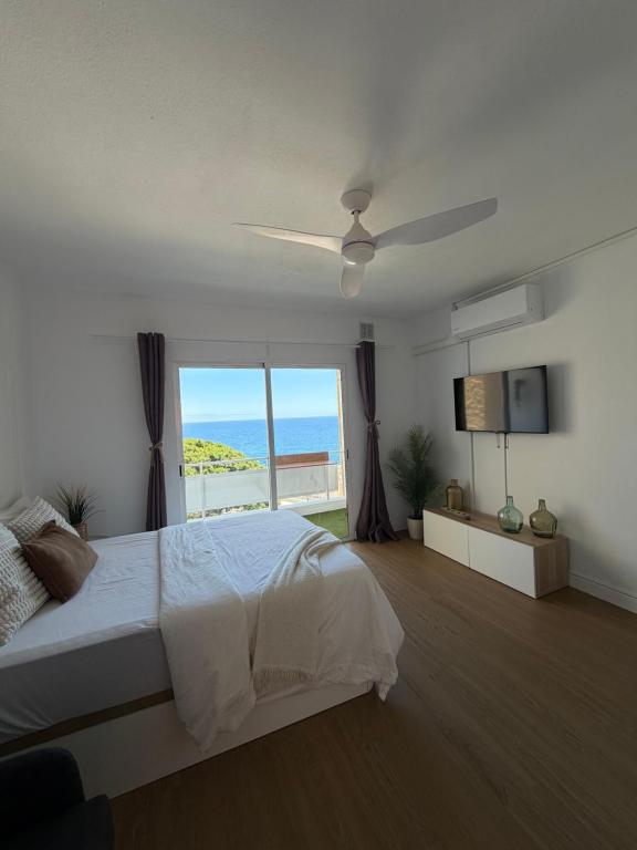 a bedroom with a bed with a view of the ocean at LĀ KAI - Piso Carabelas in Candelaria