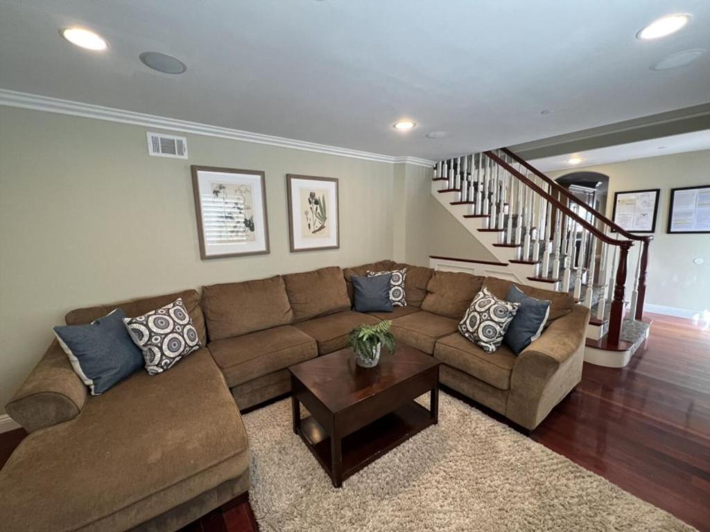 a living room with a couch and a table at Amazing Large Family Home w/Pool, 1 Mile to Disney in Anaheim