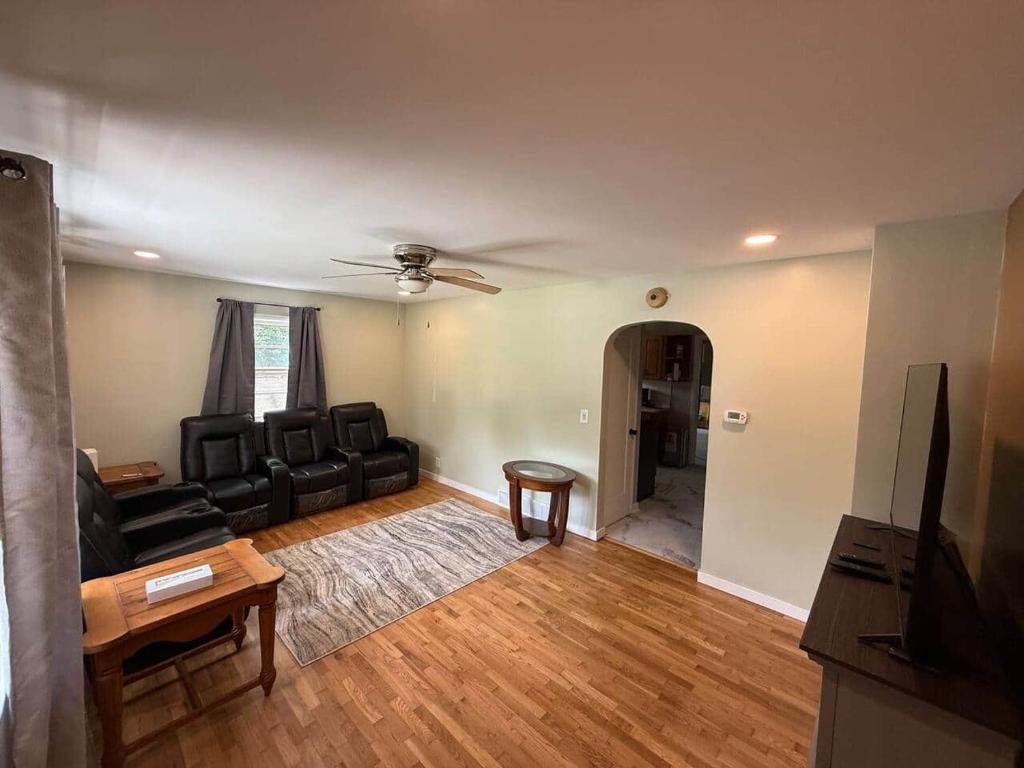 a living room with a couch and a table at The Vineyard House | Spacious Home Near Wine, Beer & Lake MI in Bridgman