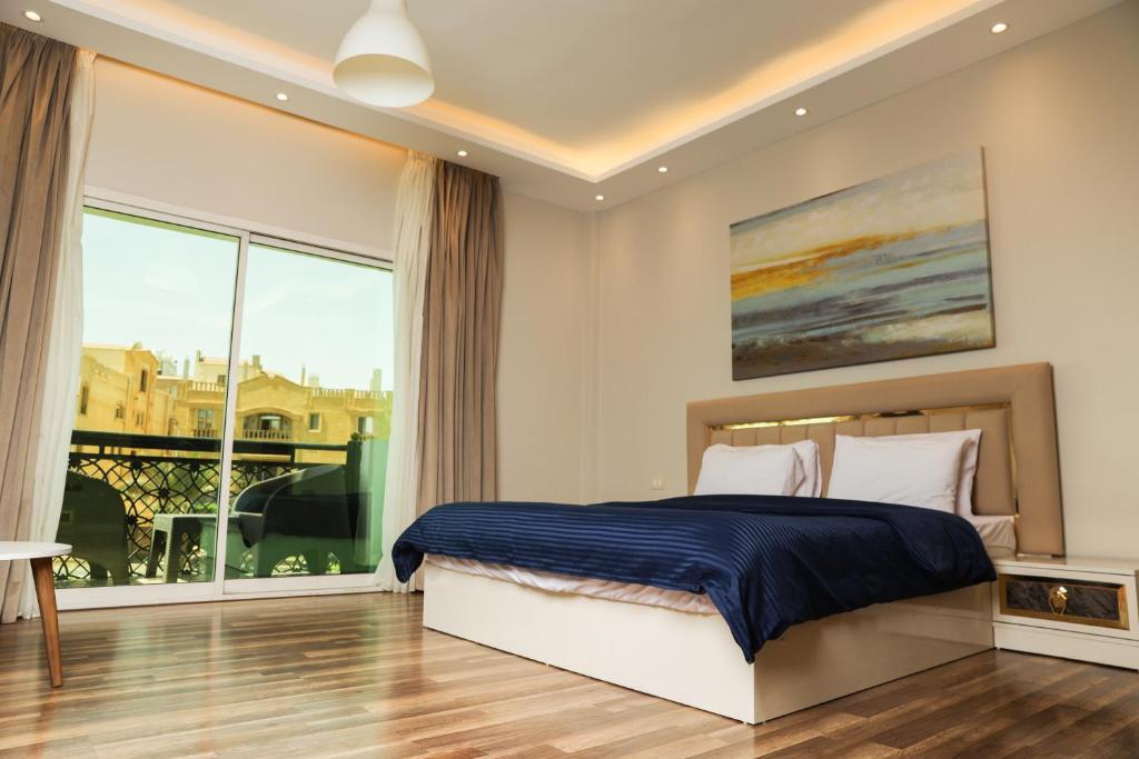 a bedroom with a bed and a large window at Munir’s residence in Cairo