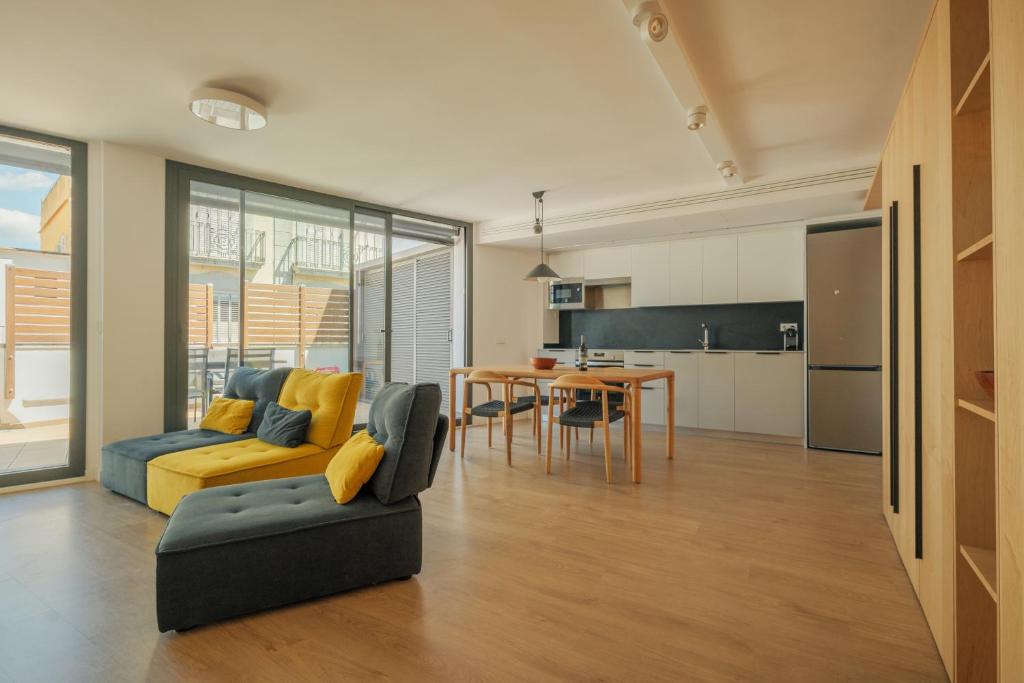 a living room with a couch and a table at Rutlla 10 in Girona
