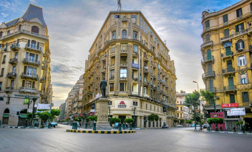 a large building on a street with two tall buildings at colombia inn cairo in Cairo