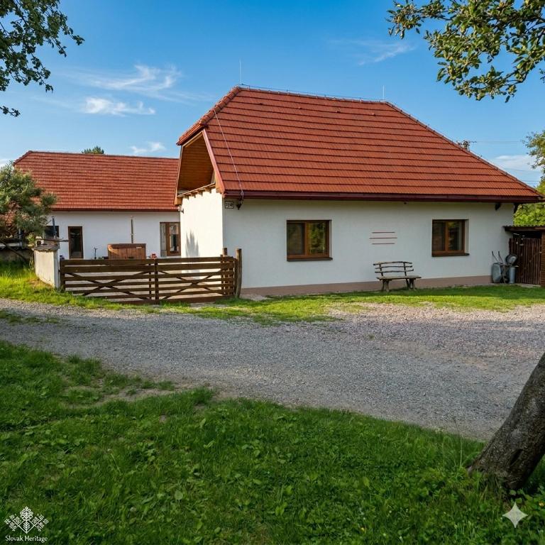 a white house with a red roof at Chata Chotár Nová Baňa in Veľká Lehota