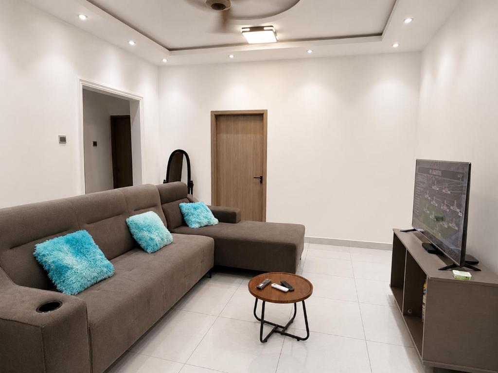 a living room with a couch and a flat screen tv at Maatambaba Homes in Tamale
