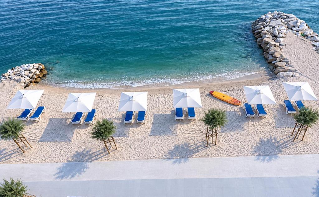 an overhead view of a beach with chairs and umbrellas at Villa Tamaris on the beach in Podstrana