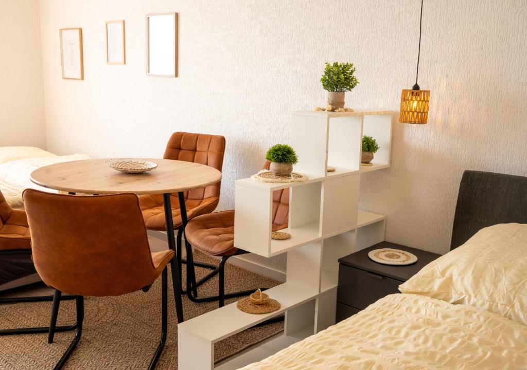 a small room with a table and chairs and a bed at Korbzimmer Apartment in Lichtenfels