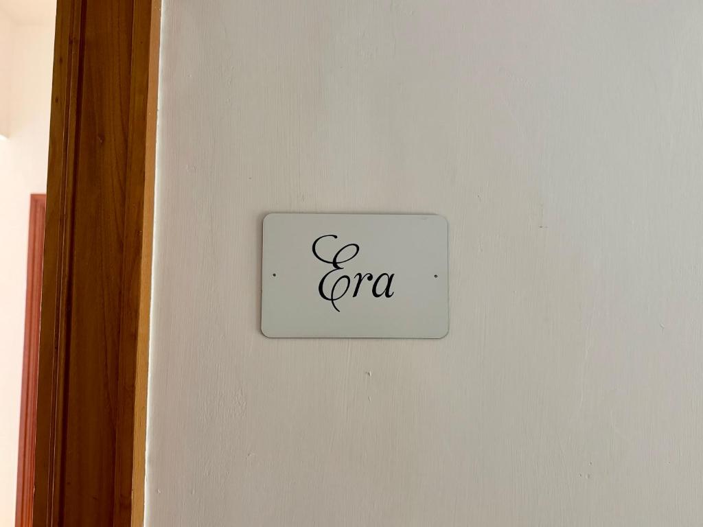 a white switch on a white wall with the wordcgi at RARE house in Agerola