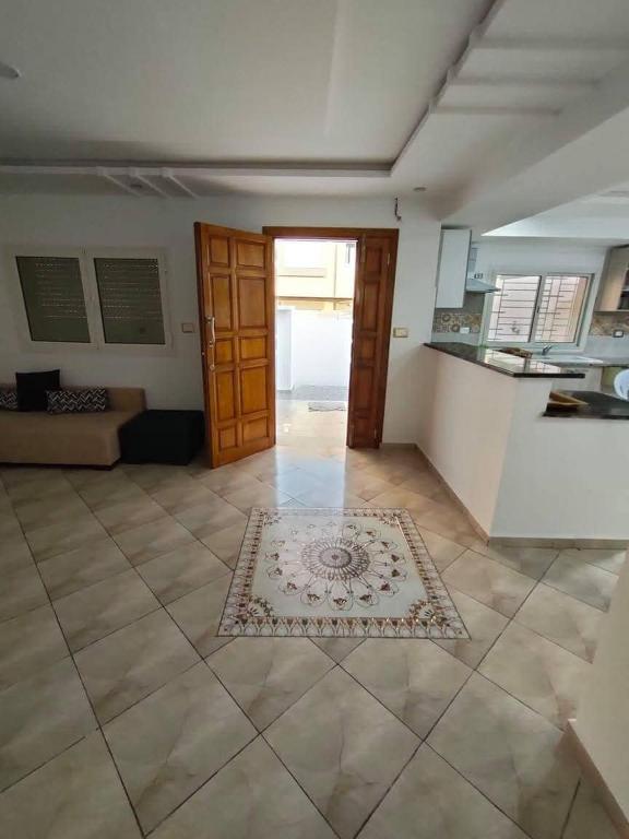 a living room with a door and a rug on the floor at Golden plage in Kelibia