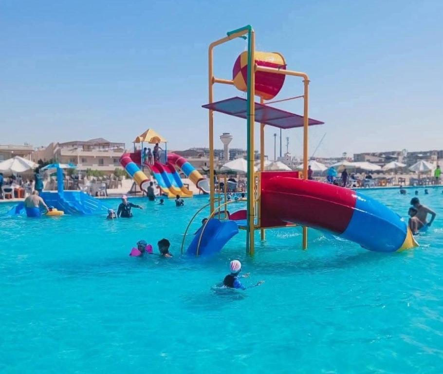 a group of people in the water at a water park at الساحل الشمالي قرية الروضة in El Alamein
