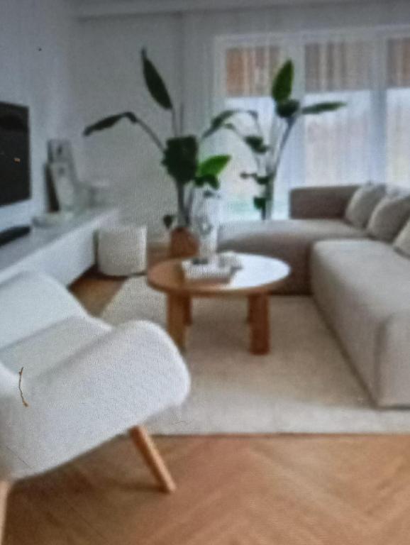 a living room with a couch and a table at Paradise apartament in Prishtinë