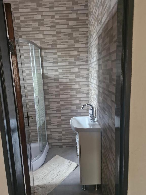 a bathroom with a sink and a bath tub at Cosy Corner Villa in Lusaka