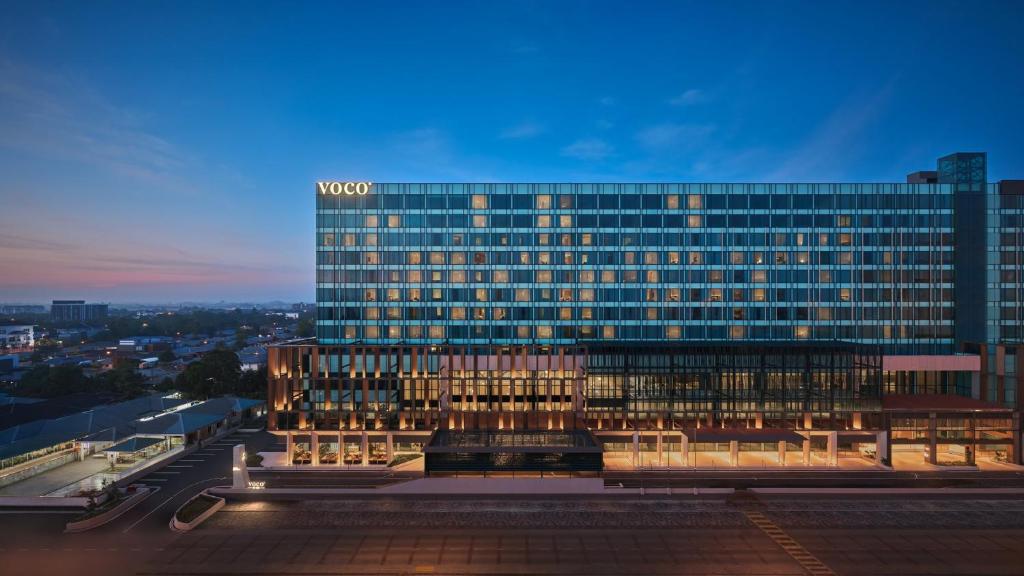 a large building with a sign on the side of it at voco Kuching by IHG in Kuching