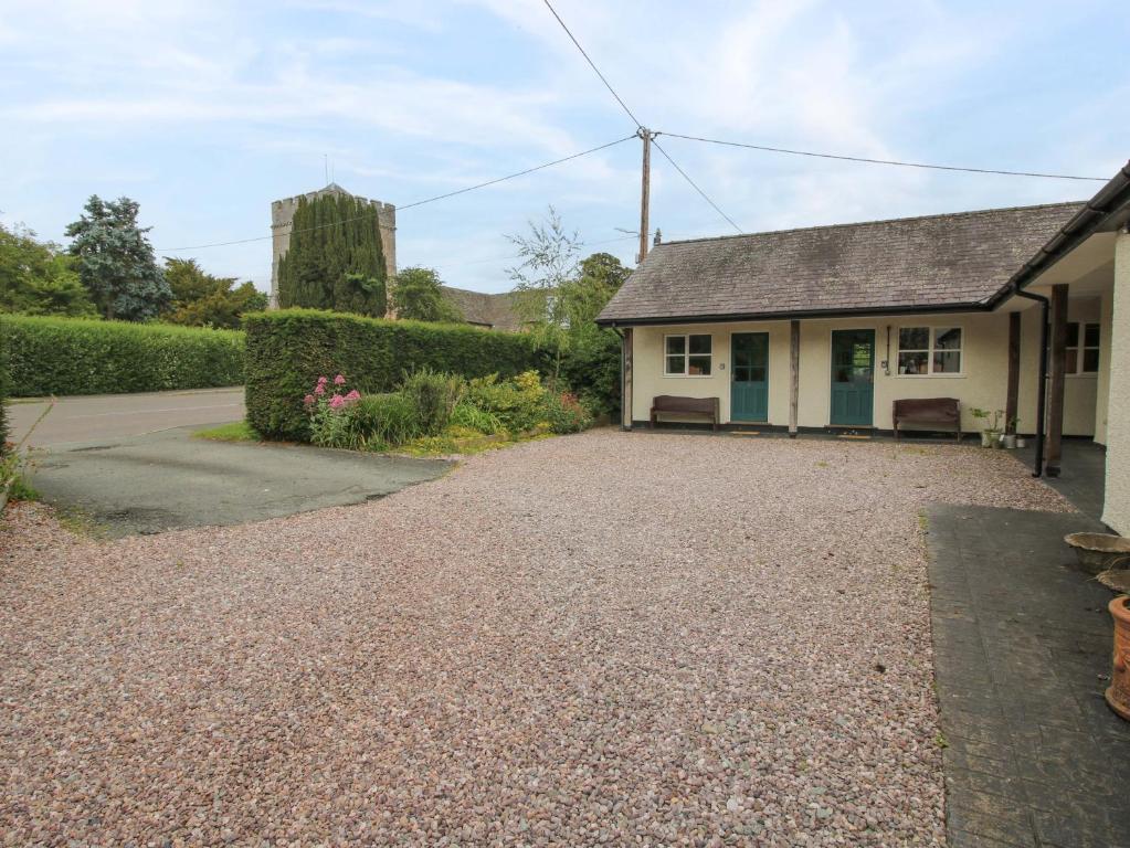 a house with a gravel driveway in front of it at Apartment 3 in North Lydbury