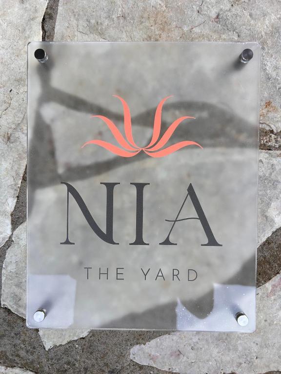 a sign for the yard with an orange spider on it at Nia The Yard in Nafpaktos