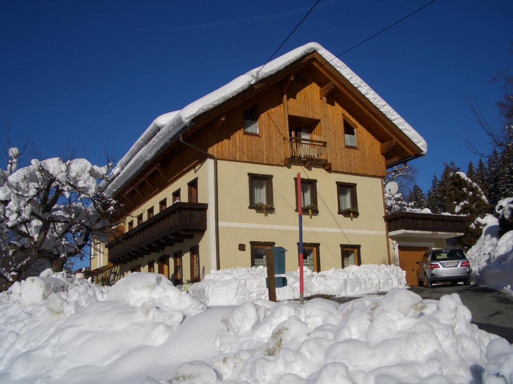 ein Gebäude mit einem Stapel Schnee davor in der Unterkunft Haus Jost Ingrid in Hermagor