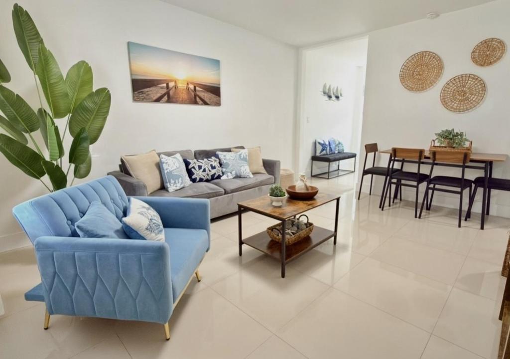a living room with a blue couch and a table at Miami Blue Oasis l 2BR with free parking in Miami
