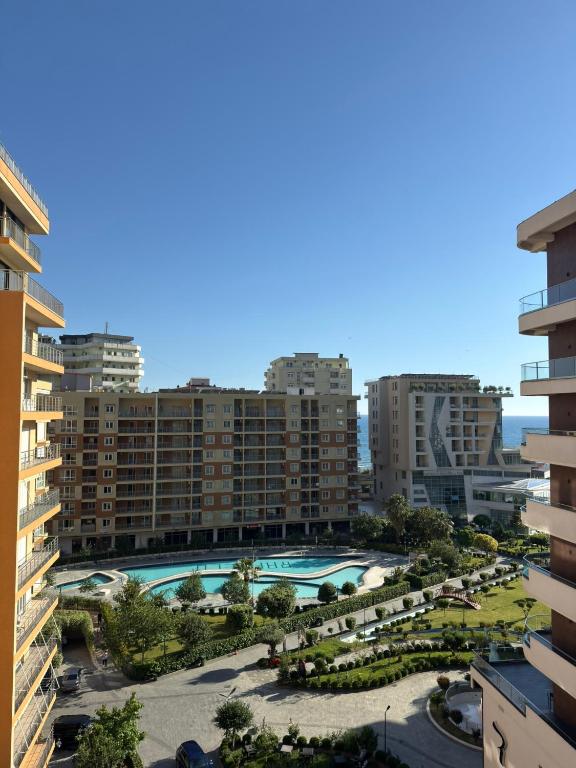 arial view of a large building with a swimming pool at Alfas Beach Apartments in Shëngjin