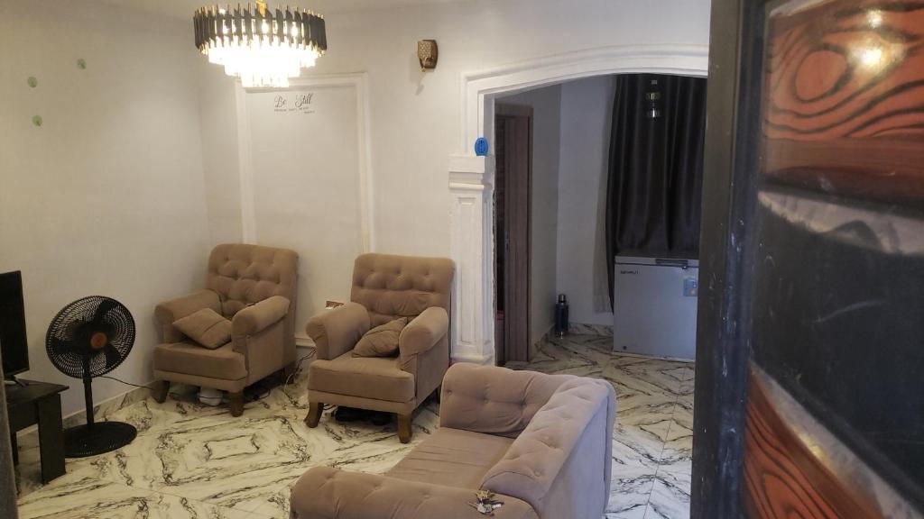 a living room with two chairs and a couch at Sejeva in Ikorodu