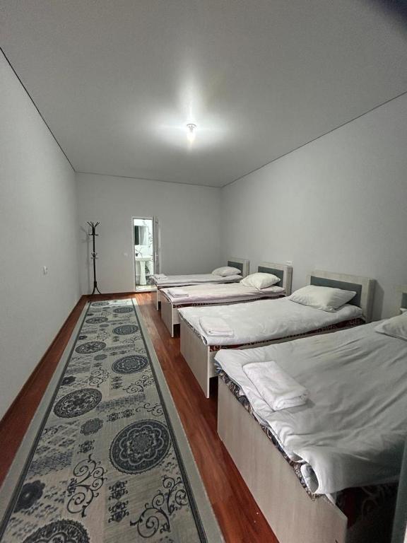 a room with four beds and a rug at Amir in Arkit