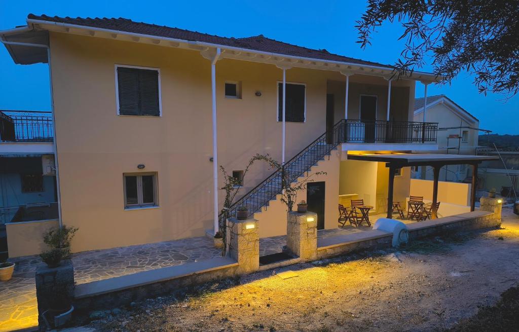 a house with a staircase in front of it at night at Irene Studios in Nydri