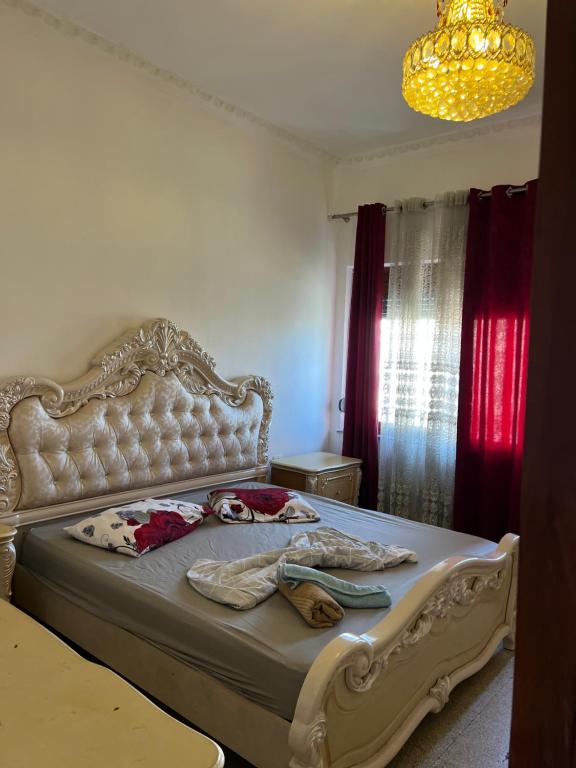 a bedroom with a large bed with a large headboard at Dyrrah Rooms Central in Durrës