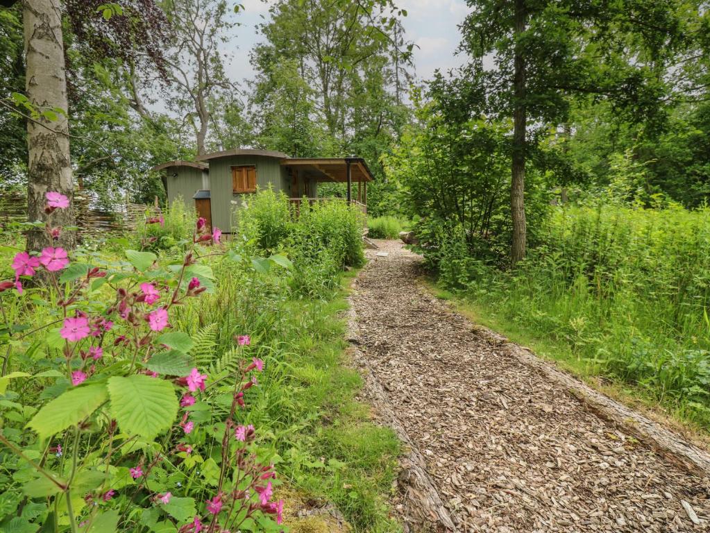 a path leading to a garden with a house at Bracken Fern in Richmond