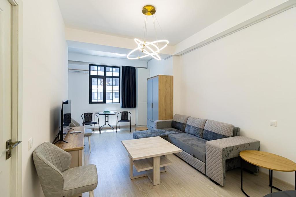 a living room with a couch and a table at Stylish 2BR Apartment in Yerevan in Yerevan