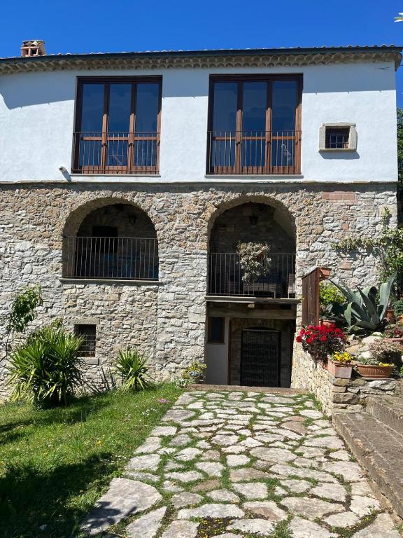 a stone house with windows and a driveway at Il Convento di Roberta in Civitanova del Sannio