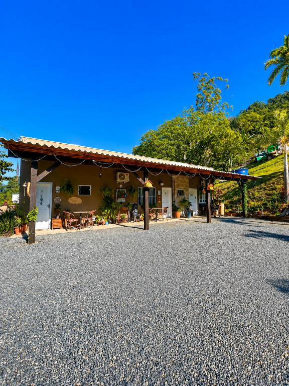 a house with a gravel driveway in front of it at Nonna Paulina in Timbó