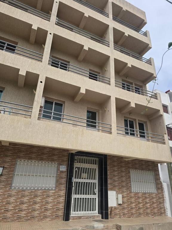an apartment building with a gate in front of it at Residence Jamal Only Family in Martil