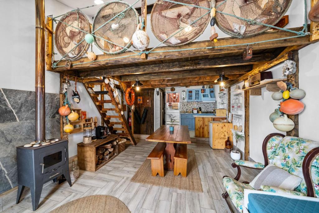a living room with a table and a stove at The Caravel Apúlia in Apúlia