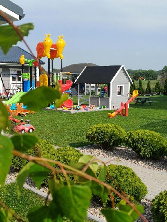 a playground in a yard with a play park at Kalimera in Sarbinowo