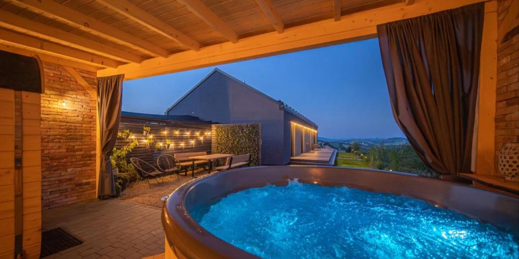 a large hot tub on the patio of a house at RosoChata313 Domek w górach z Sauną,Jacuzzi,Basenem "Panieński" ruska Bania na wyłączność in Mogilno