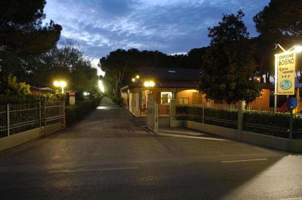 an empty street at night with lights on at Parco Vacanze Camping Sogno in Marina di Massa