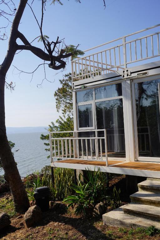 a house with a balcony overlooking the ocean at Serenity Mezcala - Abitare in Isla de Mezcala