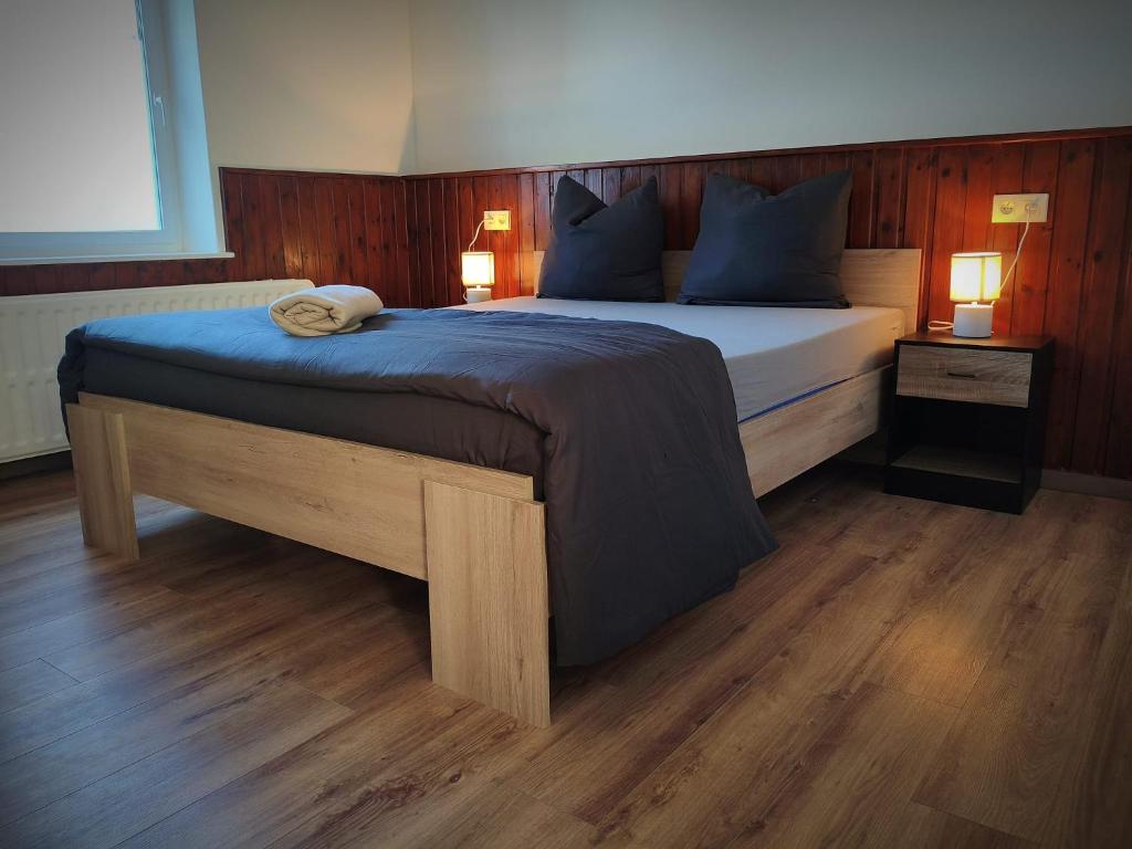a bedroom with a large bed with blue pillows at Villa Serenita in Montenau
