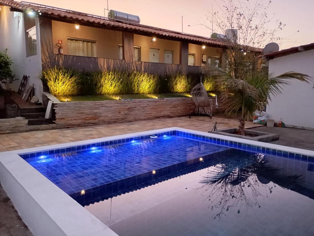 a swimming pool in a backyard with a house at Pousada Sabia Capitolio in Capitólio