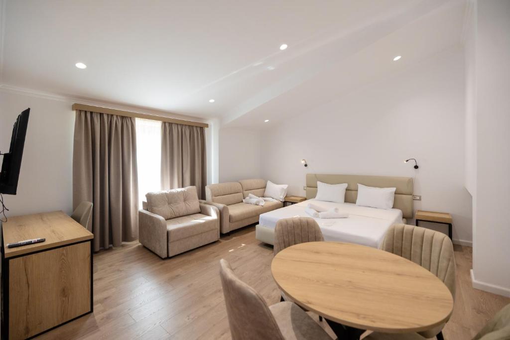 a living room with a couch and a table at Hotel Petro in Vlorë