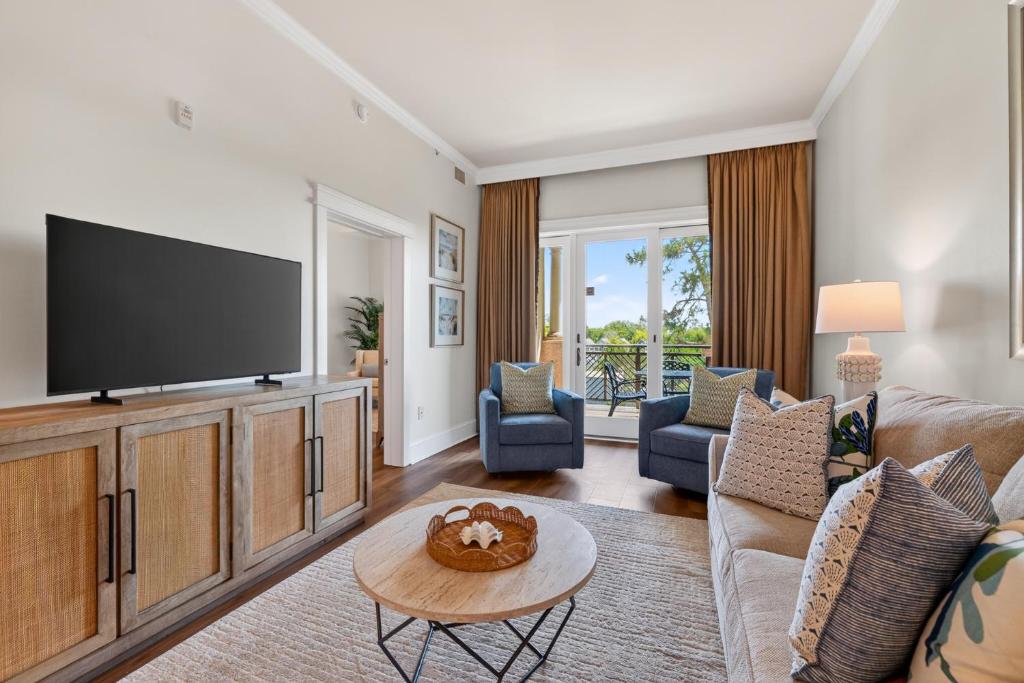 a living room with a television and a couch at Sea Gate 303 in Saint Simons Island