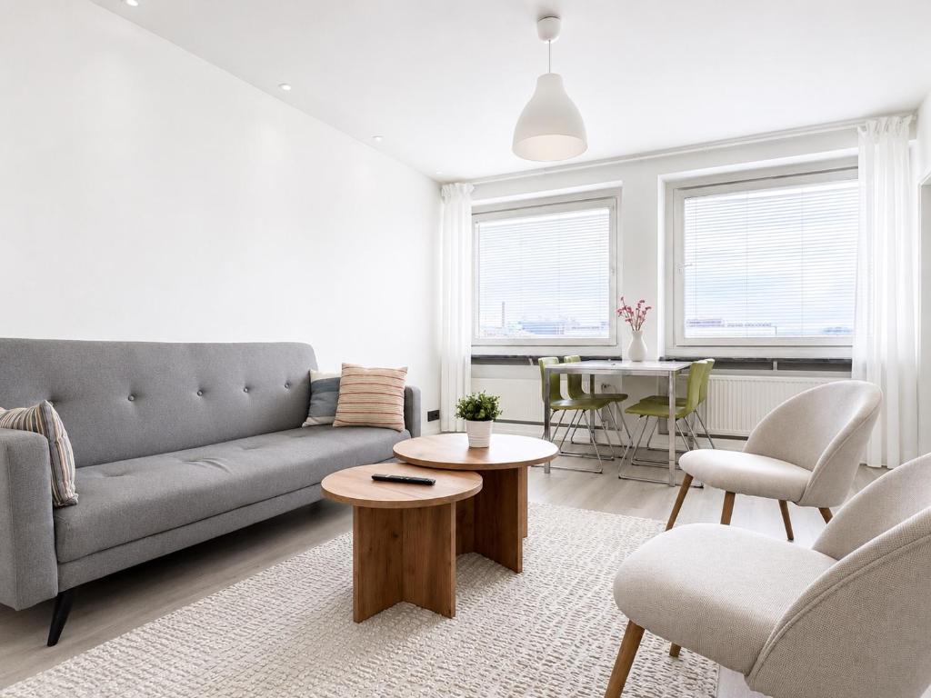 a living room with a couch and a table at Galle's 2 bedroom penthouse in Pori