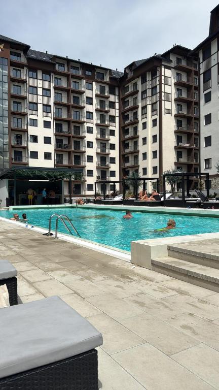 a swimming pool in front of some apartment buildings at Titova vila apartman Vardar 17 in Palisat
