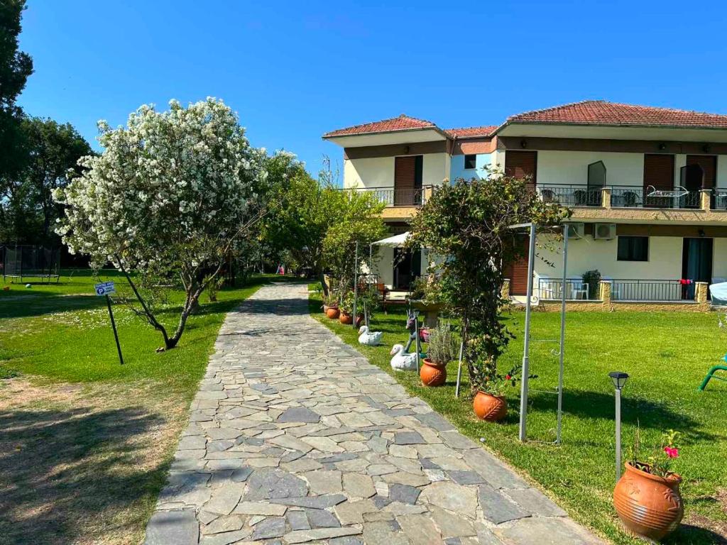 a house with a stone path in front of it at LEFKADIOS HERN studios in Lefkada