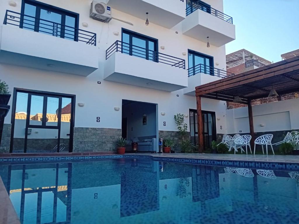 a view of a house with a swimming pool at pure peace hotel in Luxor