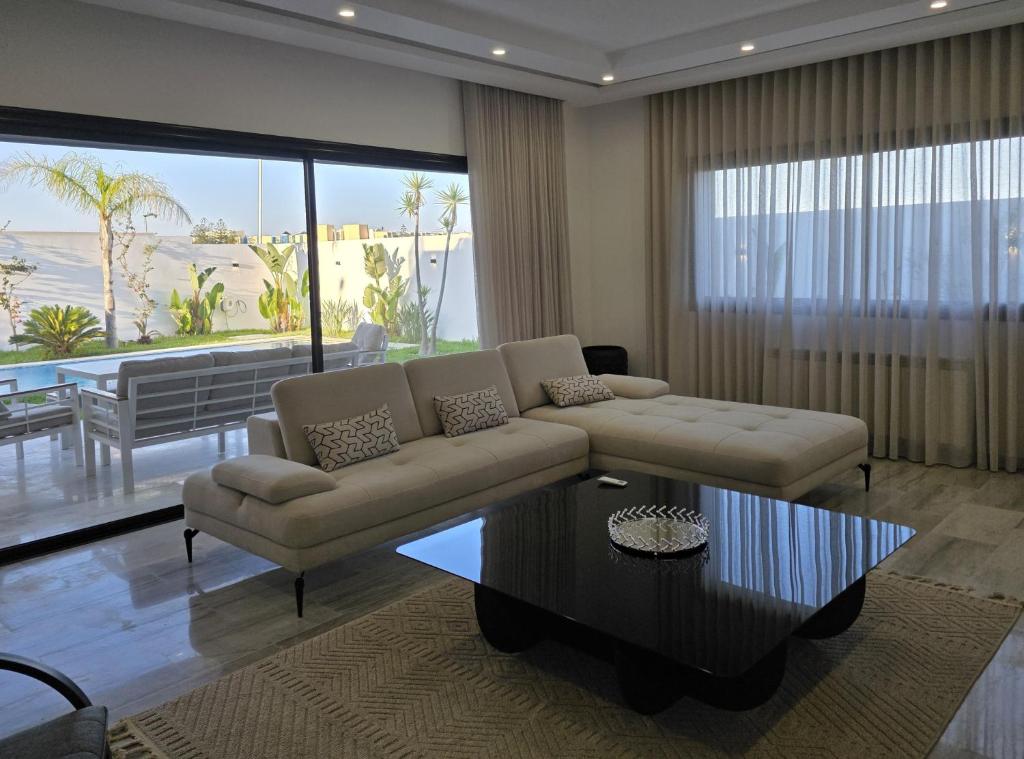 a living room with a couch and a coffee table at Villa Sunrise in Hammamet