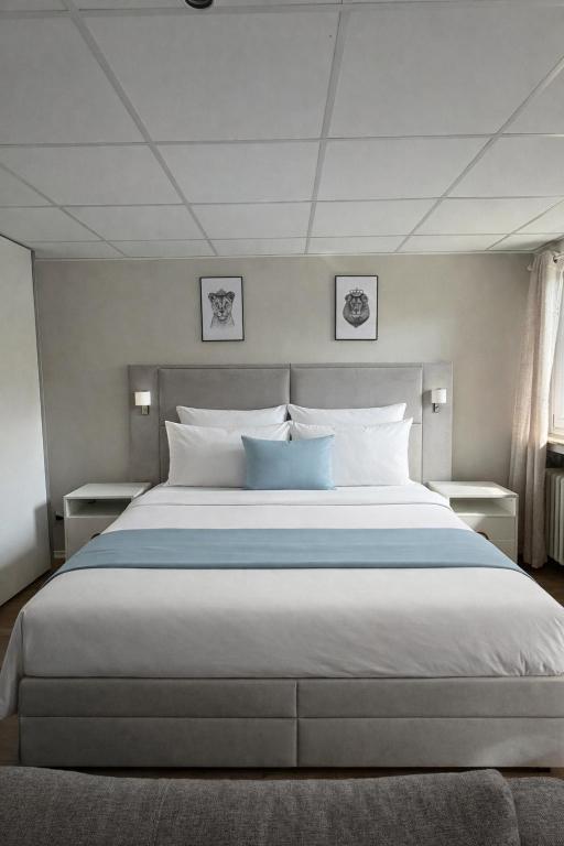 a bedroom with a large bed with two pillows at Apartment Landglück Overath in Overath