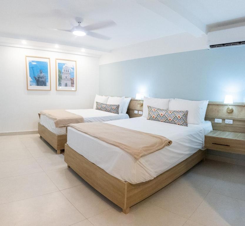 a bedroom with two beds in a room at Colonial studio with 2 Beds - Patio Español in Santo Domingo