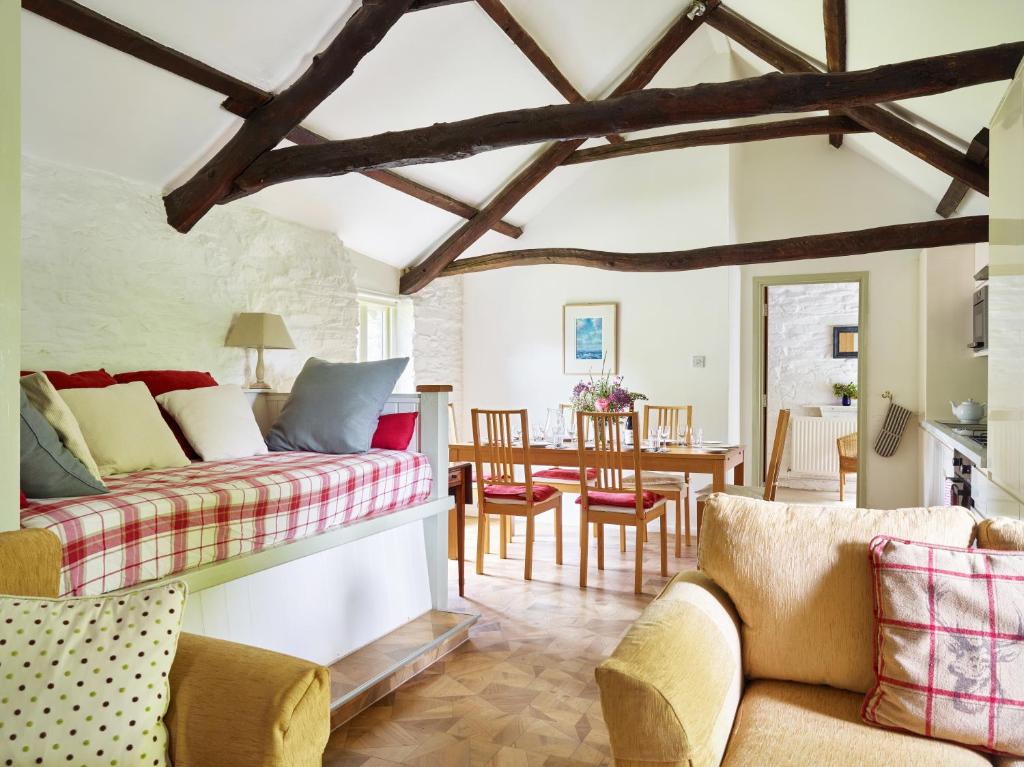 a living room with a couch and a table at Trevadlock Manor by Smart Welcomes in Launceston